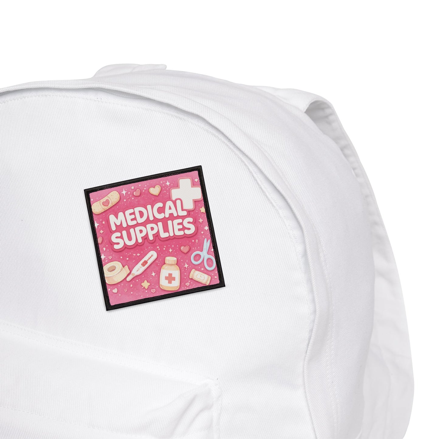 White pillow with a pink 'Medical Supplies' patch on a white background