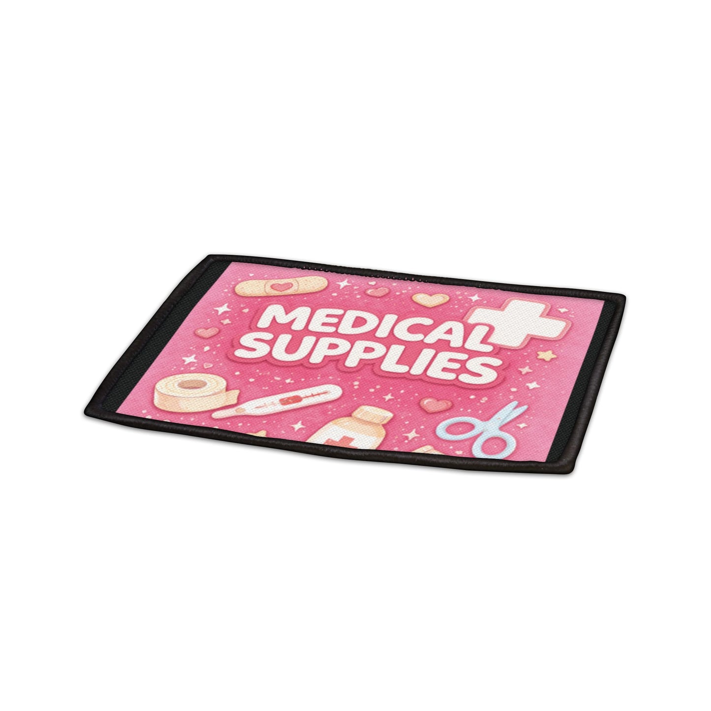 Pink mat with 'Medical Supplies' text and medical icons on a white background